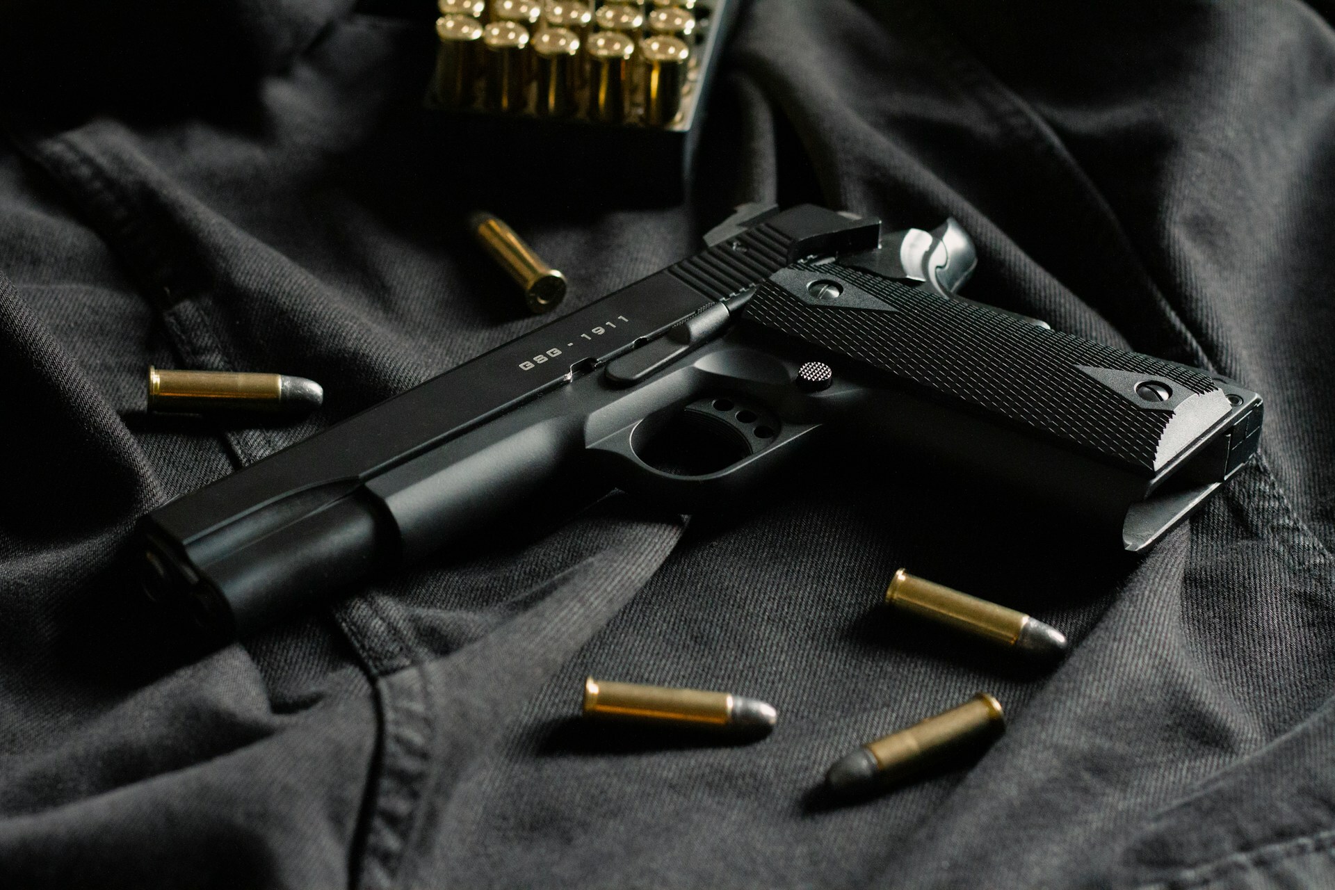 1911 on black jeans with bullets around it