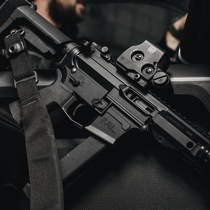  A custom 9mm AR rifle featuring an optic and sling