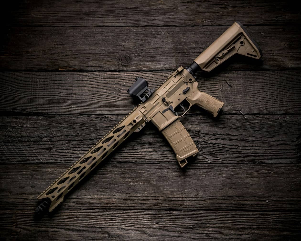 brown rifle on dark wood surface