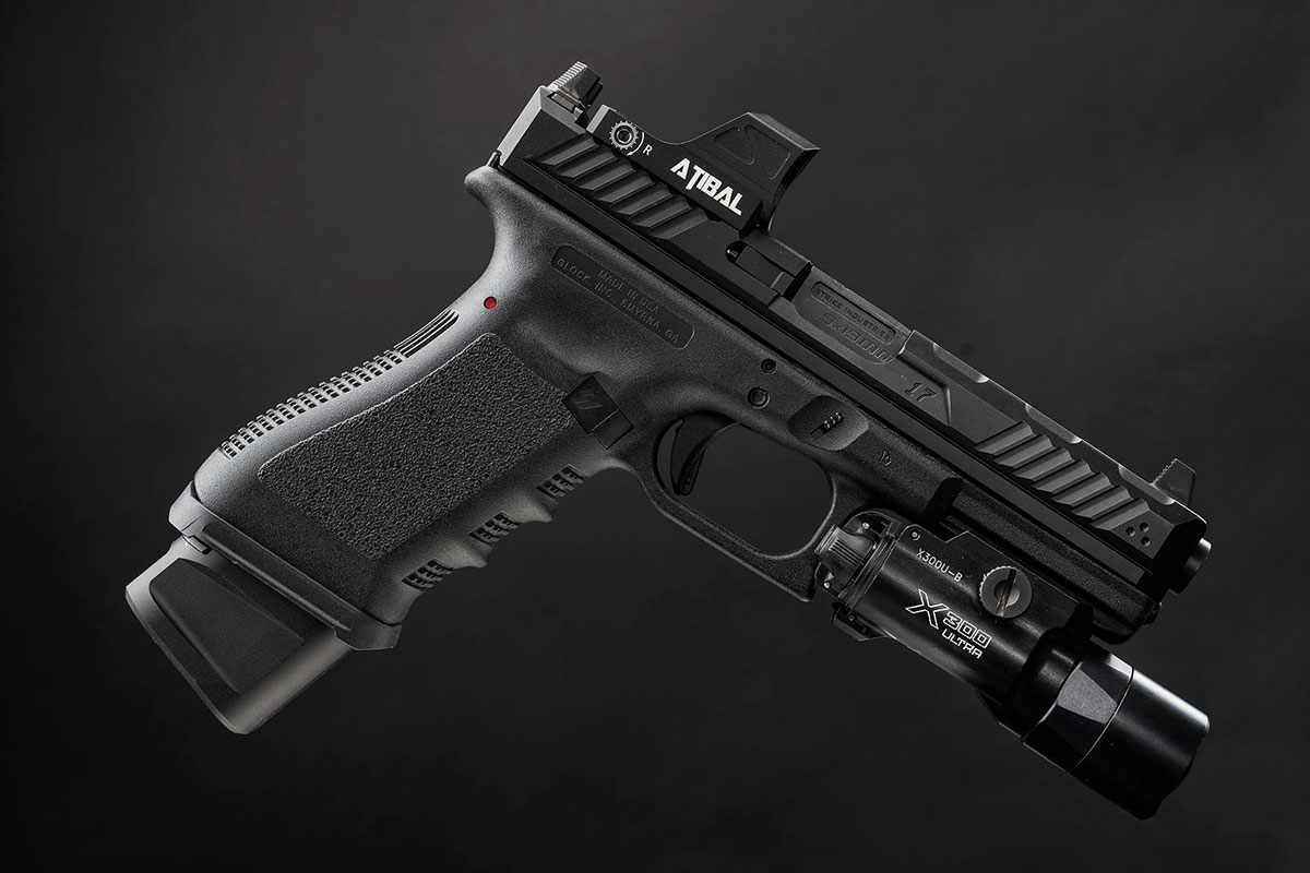: Trigger, trigger guard, magazine release, and grip on a Glock handgun