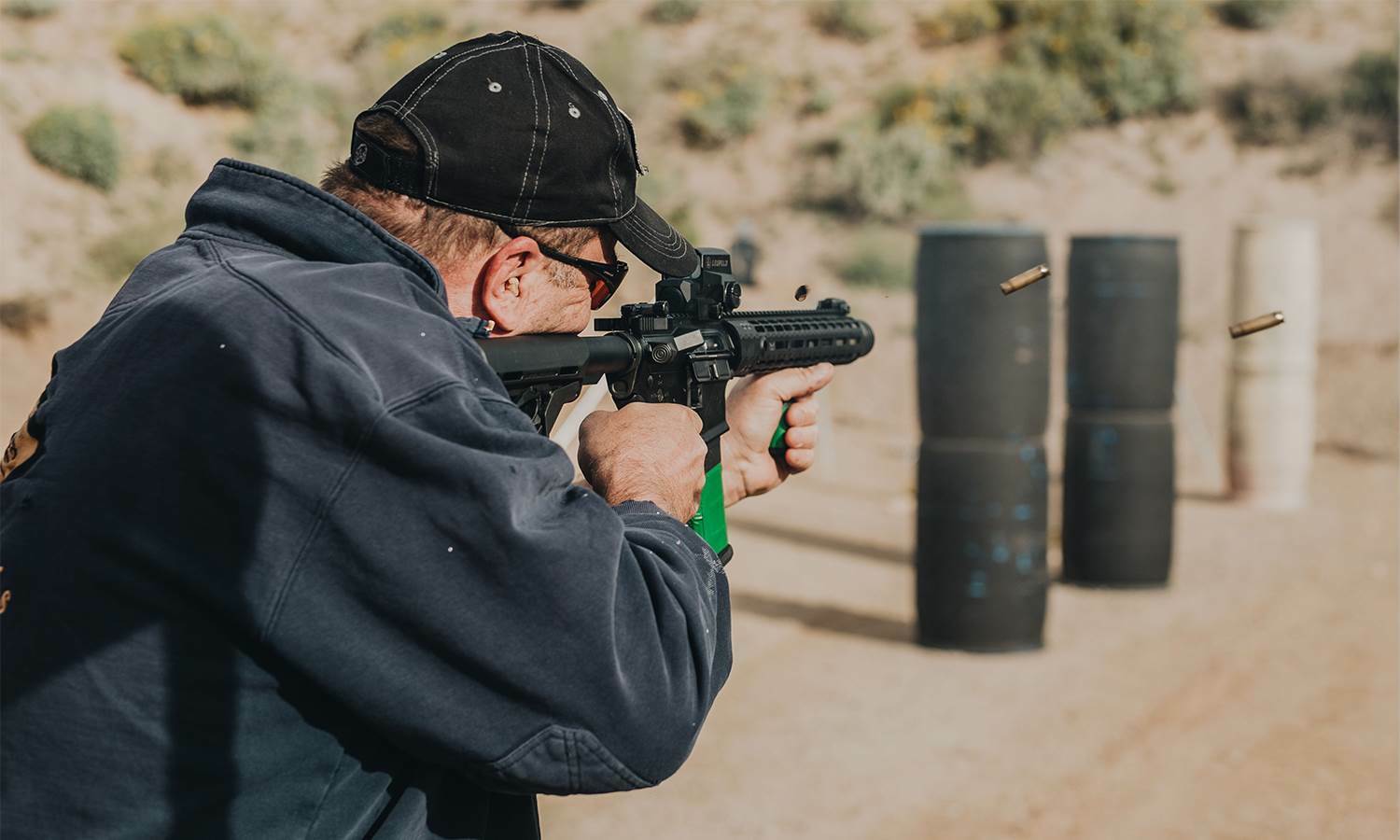 A shooter takes aim with a custom rifle at the range