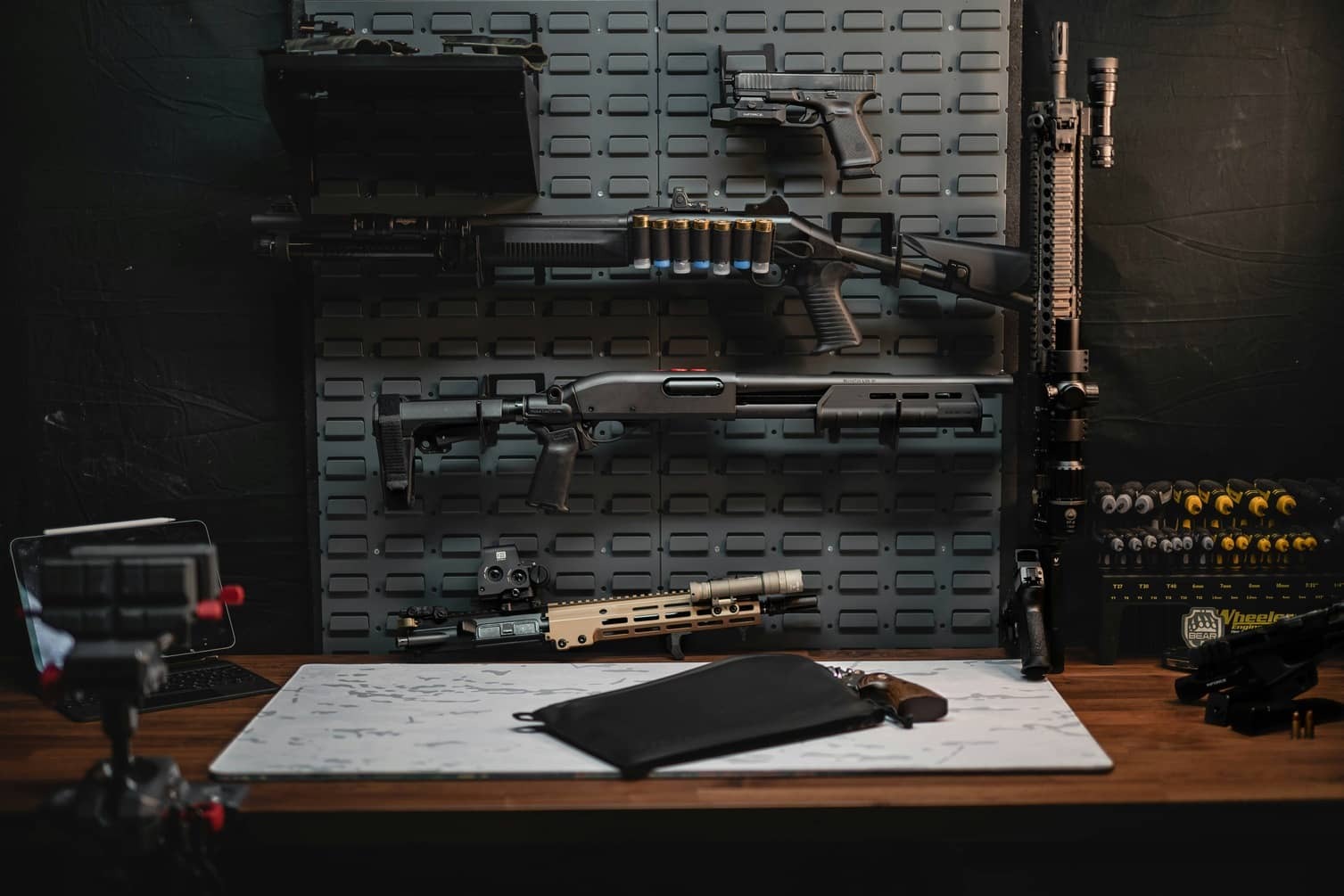 guns mounted on wall above workbench