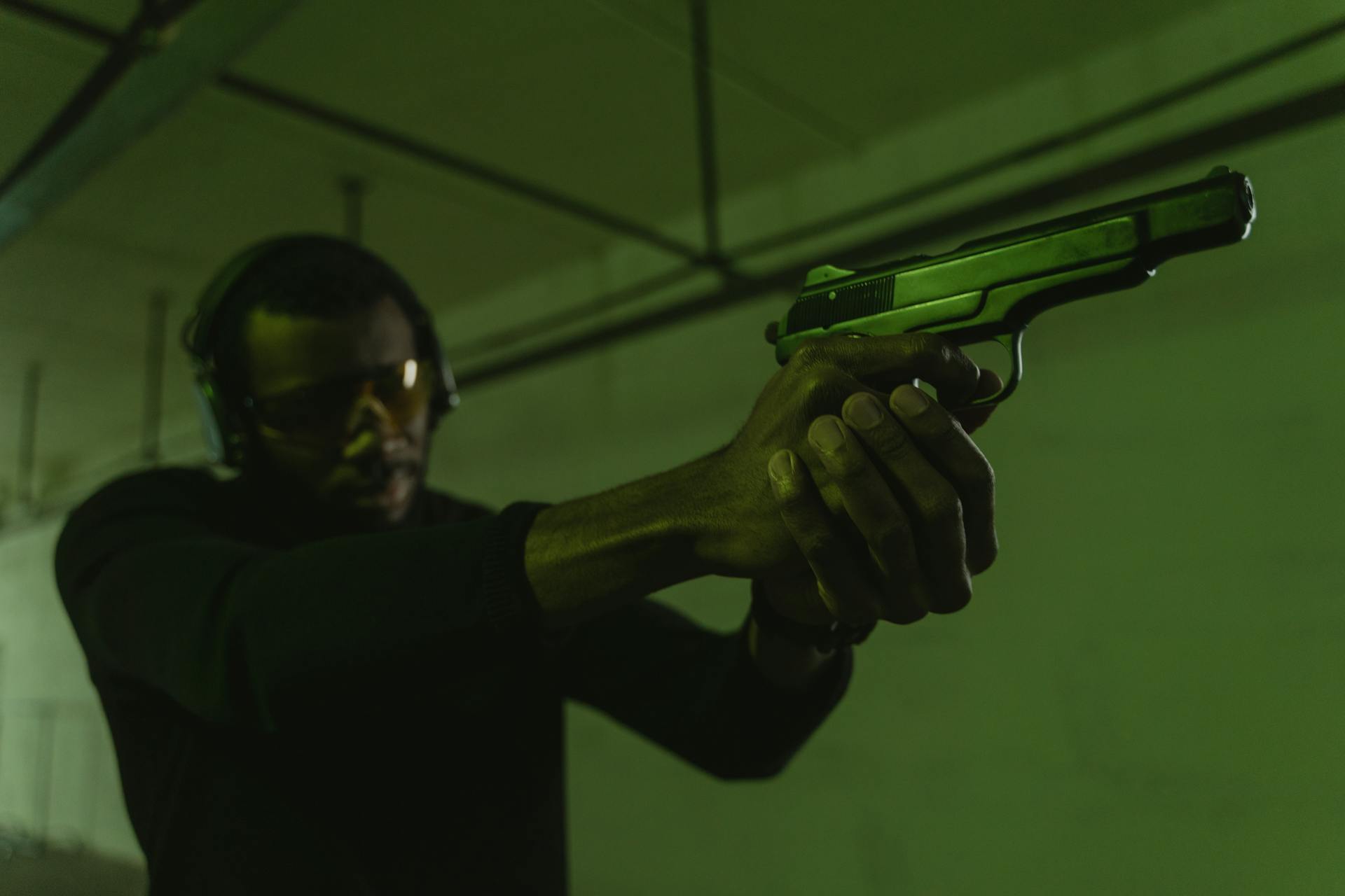 Man holding pistol in gun range