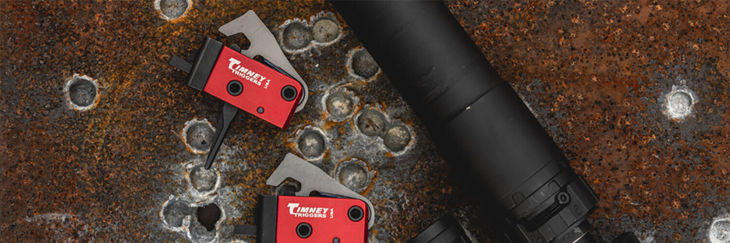 Timney triggers laying on steel plate