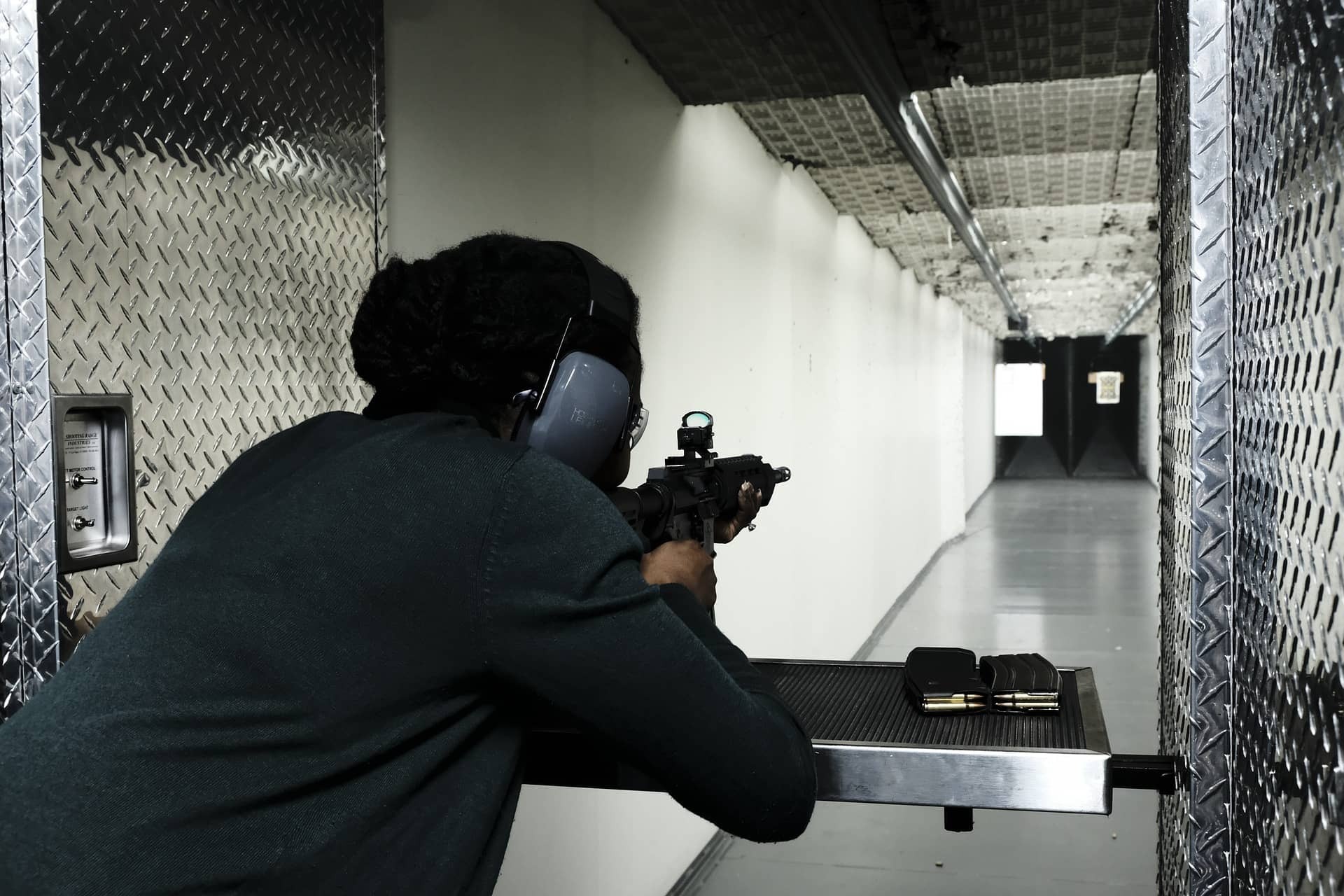 Picture of a woman firing a gun indoors