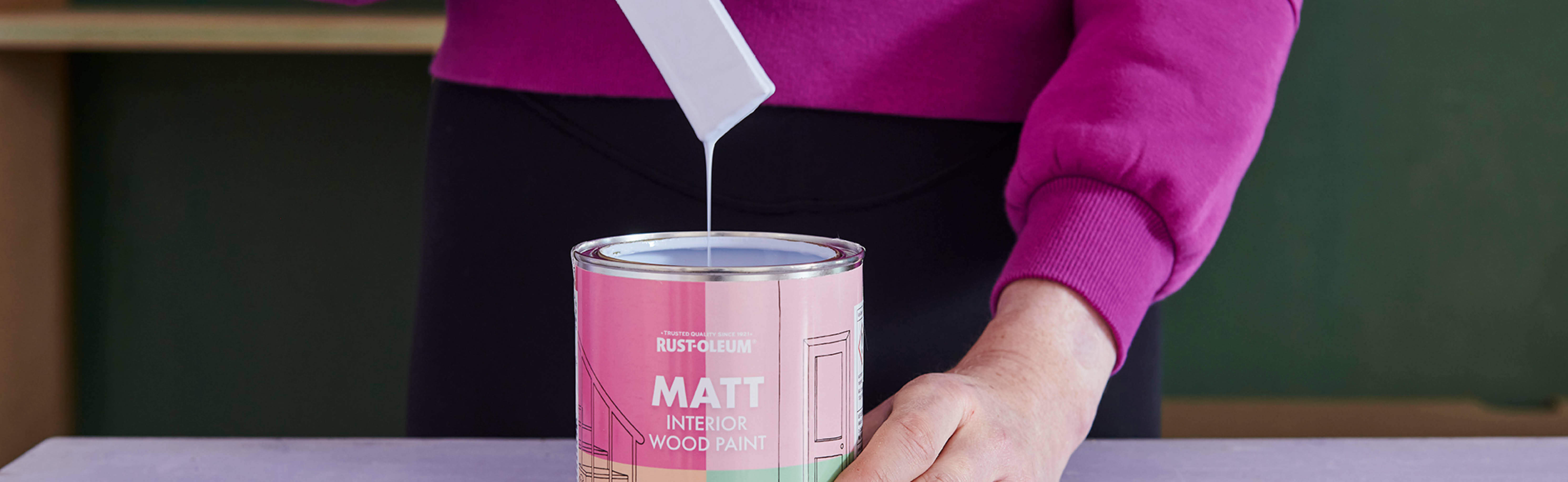 Stirring a can of Interior Wood Paint in Powder Blue
