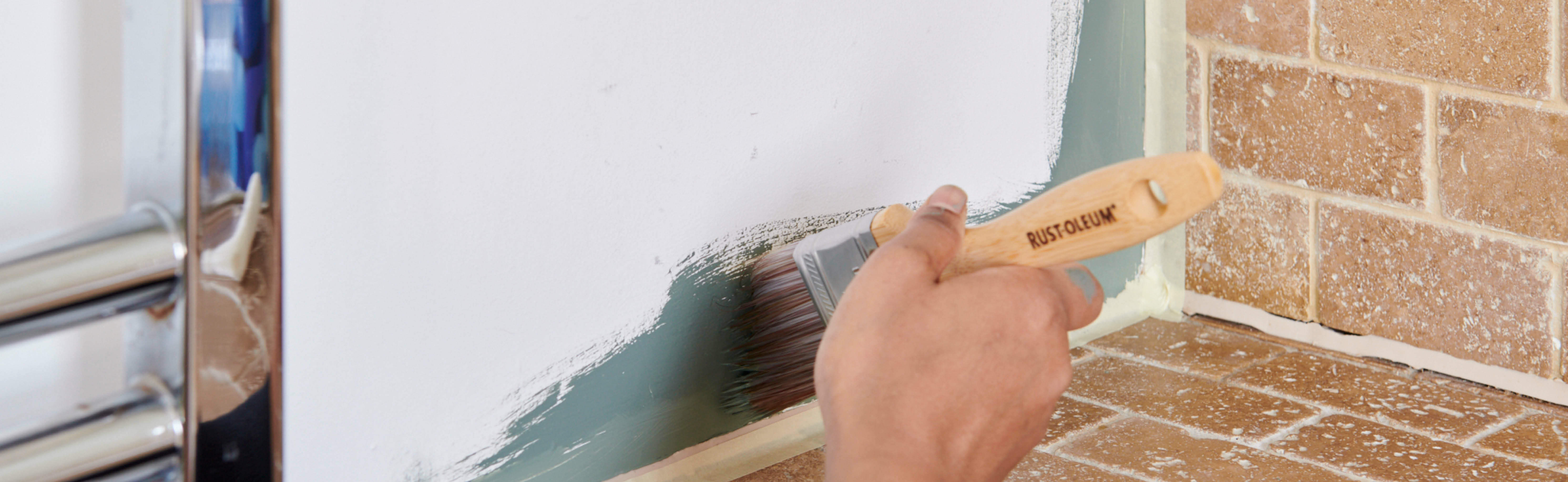 Painting a wall with blue-green Serenity