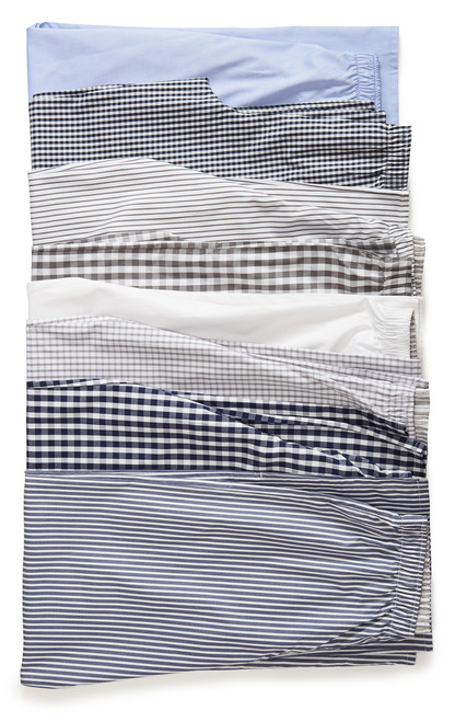 Our array of Pajama Pants in order from top to bottom: light blue oxford, indigo gingham, slate stripe, smoked gray pearl check, crisp white pinpoint, gray windows, marine blue check, and military blue stripe. All are fashioned with 100% pinpoint cotton and feature an interior waistband created with our signature gray-and-white-stripe.