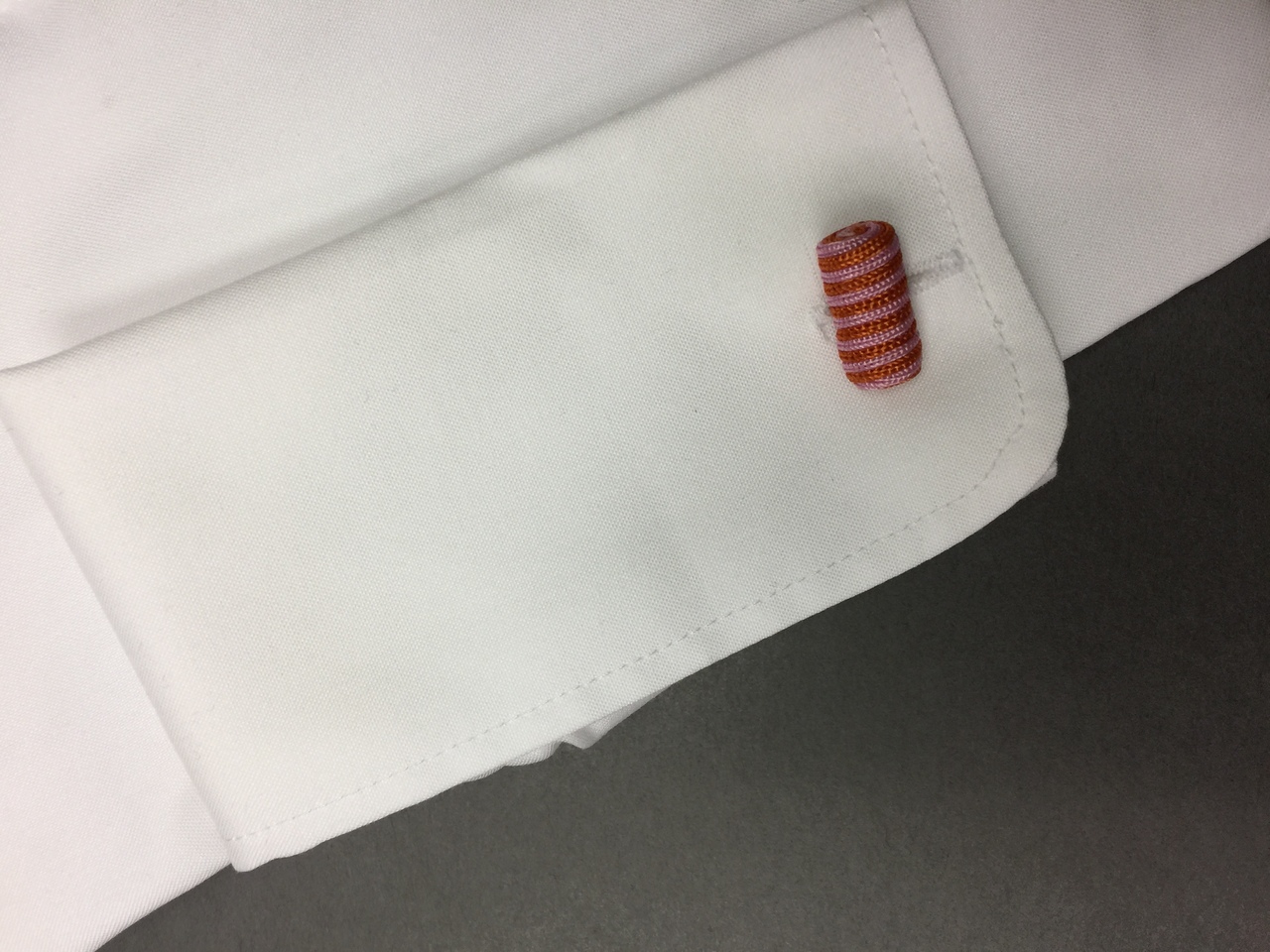 The C + K Cufflink in pink and red.