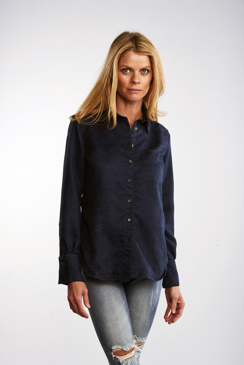 The Suede Ivy in dark blue, worn untucked.