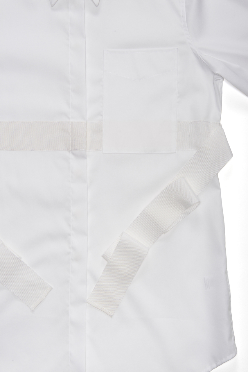 A close up view of the white grosgrain ribbon belt.