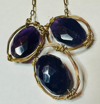 This necklace resembles a birds nest.  The stones are cradled in by hand and wrapped with gold fill wire.  It comes on a 18" chain.

Amethyst is an extremely powerful and protective stone with a high spiritual vibration.  I natural tranquilizer.  Its natural serenity enhances higher states of consciousness and meditation.

Country of Origin - United States, Britain, Canada, Brazil, Mexico, Russia, Sri Lanka, Uruguay, East Africa, Siberia, India