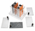Electrochemical reaction kit shown on a clean white background with a clear plastic battery box, copper electrode plates, and interchangeable metal electrodes with black binding posts for wet cell battery experiments.