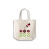 A calico bag with a short handle featuring a design of flowers and a character, in a light cream colour.