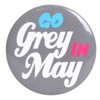 A grey button badge featuring bold, colourful text. It has a logo in the design.