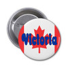 A round button badge featuring a red and white design with a Canadian maple leaf and the word "Victoria" in blue.