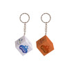 Two 3x3 puzzle cube keyrings, one in white with a logo and the other in orange, attached to metal keychains.