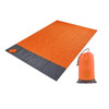 An orange and grey picnic blanket laid out beside a matching pouch for storage. The blanket features a soft texture.