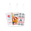 Three colourful swing tags with designs featuring a hot air balloon, beach umbrella, and festive plaid patterns. Each tag has a white string.