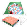 A rectangular outdoor blanket in green, featuring a picnic design, folded with stakes included.