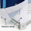 A close-up of a Velcro strip on a blue and white display wall, highlighting attachment details.