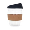 A reusable glass coffee cup with a cork band and a dark navy lid, designed for on-the-go drinks.