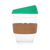 A reusable glass coffee cup with a cork band and a green silicone lid, featuring a clear glass body.