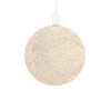 A circular, eco-friendly wireless charger in a speckled beige colour, connected by a white charging cable.