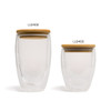 A double wall glass cup featuring a wooden lid, presented in clear glass. Available in two sizes.