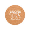 A cork round coaster featuring a playful character design with white graphics on a natural cork background.