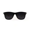 Bamboo sunglasses with a black frame and dark lenses, featuring a logo on the side.