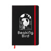 A black A5 notebook featuring a graphic design on the cover, secured with a red elastic band.