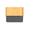 A Bluetooth speaker with a bamboo exterior and a dark gray base featuring control buttons for playback.