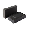 A black wireless power bank with a sleek design, presented in a matching black box with a cushioned interior.