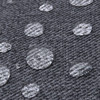 A close-up of grey fabric with water droplets beading on its surface, showcasing its water-resistant texture.