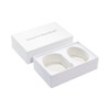 A large white gift box containing two health bracelets, featuring a simple, elegant design.