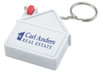 A house-shaped tape measure in white with a keyring attachment and a red button, featuring a logo.