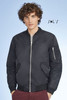 A black unisex bomber jacket featuring a zip front and side pockets, with a fabric patch on the sleeve.