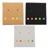 Three envelope-shaped pouches in brown, black, and white, each featuring colourful dot accents in pink, yellow, and green.