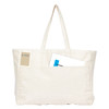 A large cream tote bag featuring a front pocket, with assorted items partially visible inside. It has a branding logo.