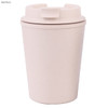A reusable coffee cup in a light pink colour, made from bamboo, featuring a lid and a logo.