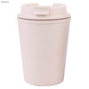 A reusable coffee cup in a soft pink shade with a lid, made from bamboo material. Features a logo.