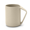 A reusable coffee cup in beige with a sturdy handle and a simple, modern design. It features a logo.