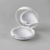 A white compact with a mirror, designed for lip gloss or lip balm. The interior is smoothly finished.