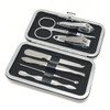 A silver manicure set contains scissors, nail clippers, tweezers, and other grooming tools in a compact case.