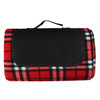 A red and black checkered picnic blanket with a black carry strap and a folded design. It features a logo on the front.