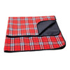 A red and blue checked picnic blanket folded with a black underside, featuring a stitched border and logo.