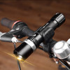 A sleek black torch mounted on a bicycle handlebar, featuring a sturdy design and a bright light beam.