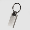 A silver keychain with a rectangular pendant and a circular ring, featuring a simple, sleek design.