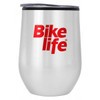 A drink bottle in a silver stainless steel finish with a black lid and a red logo.